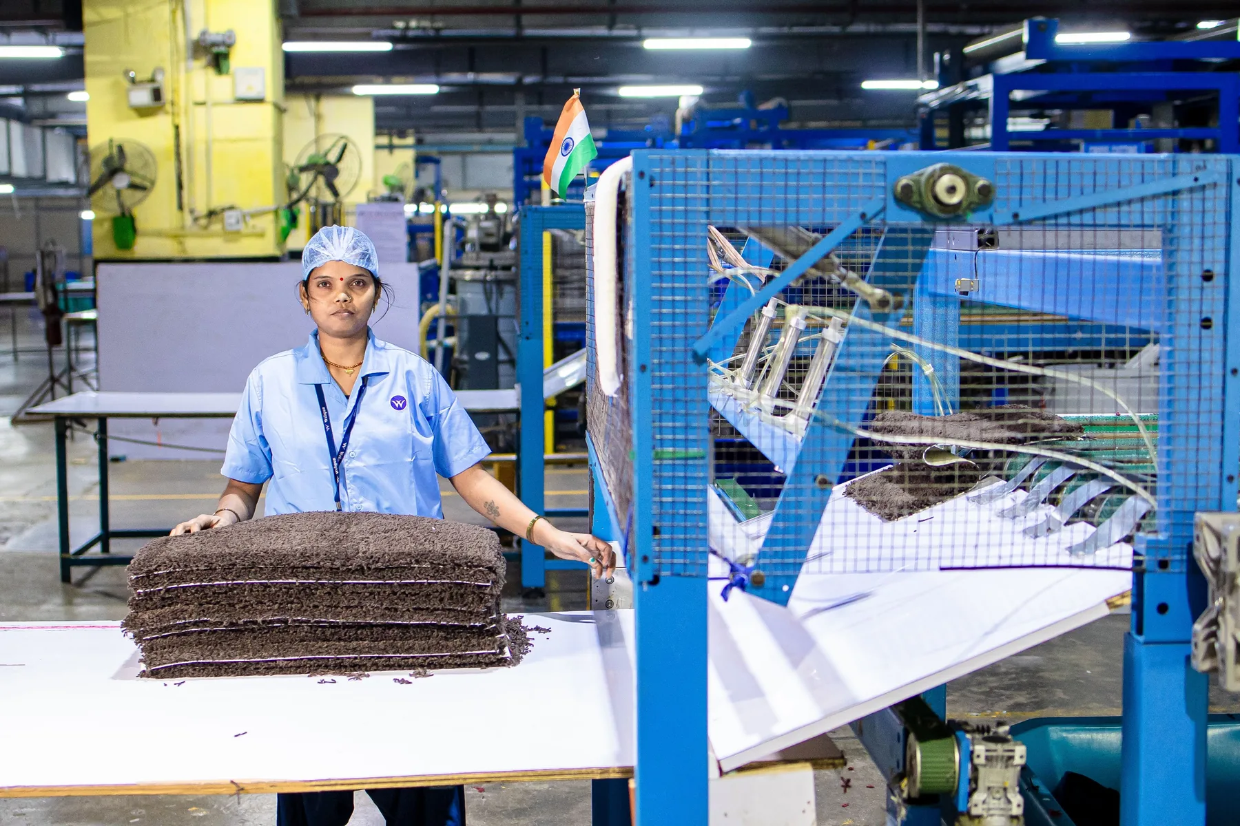 Indian manufacturing employee working with industrial machinery